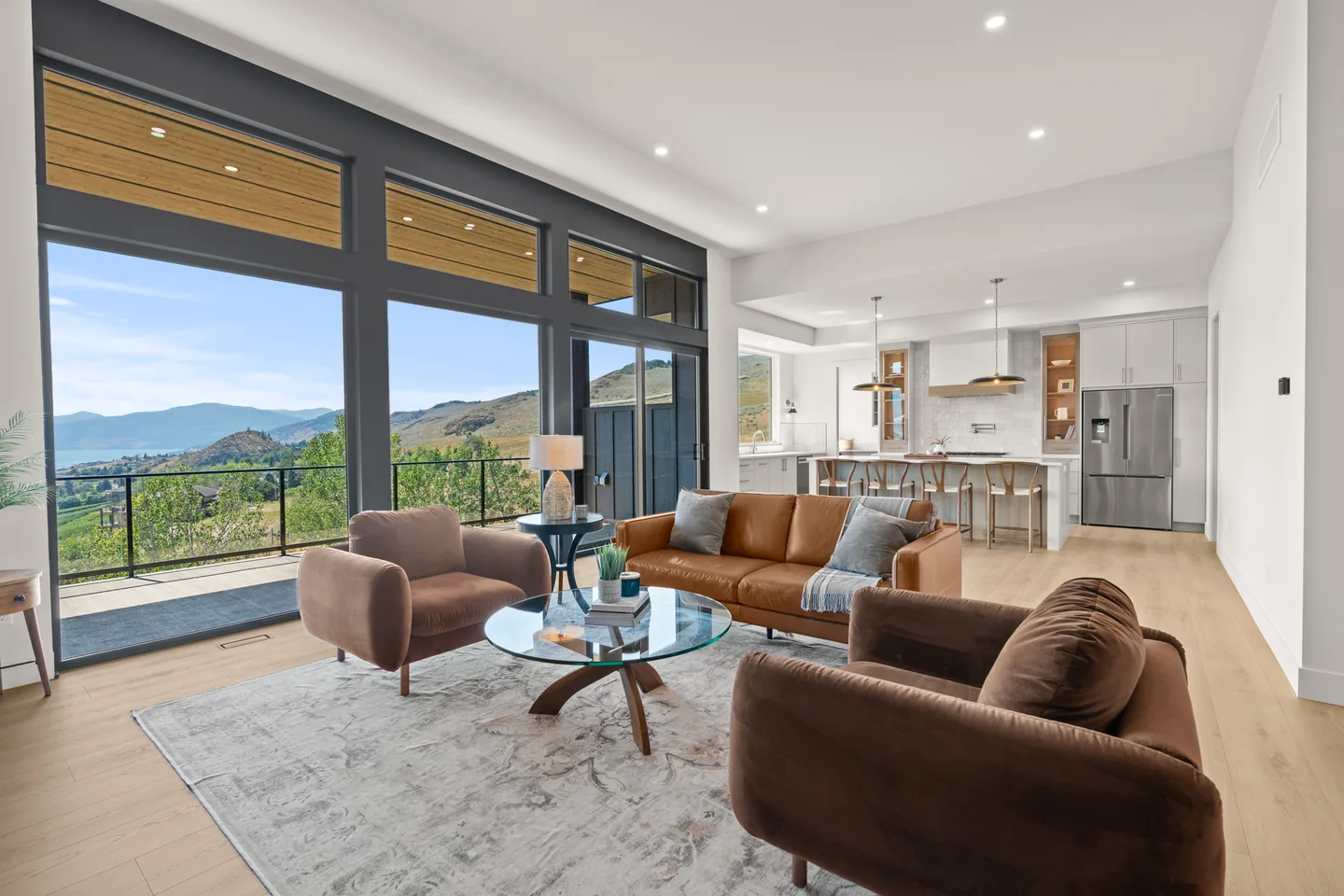 Great room with a wall of windows and the kitchen beyond